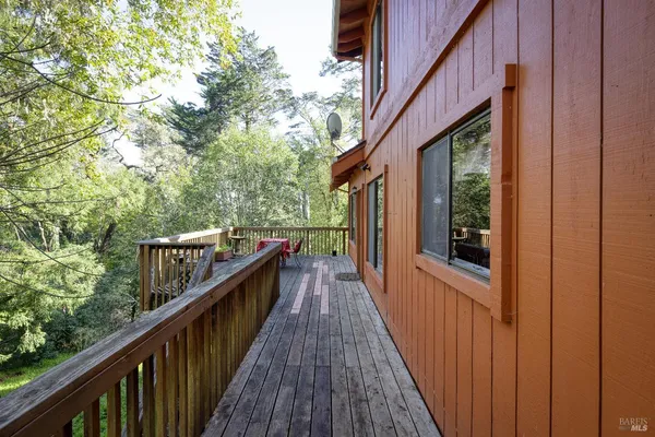 a view of balcony with wooden floor and fence