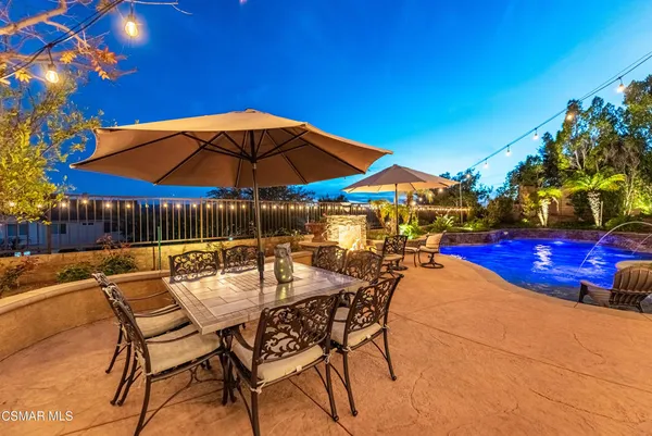 a view of a dining room with furniture and a chandelier