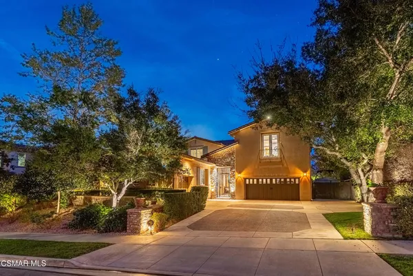 a front view of a house with a blue gate