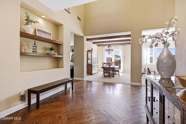 a large kitchen with stainless steel appliances granite countertop a lot of cabinets and wooden floor