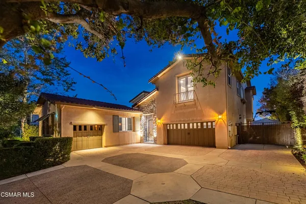 an aerial view of a house with yard seating area and fire pit