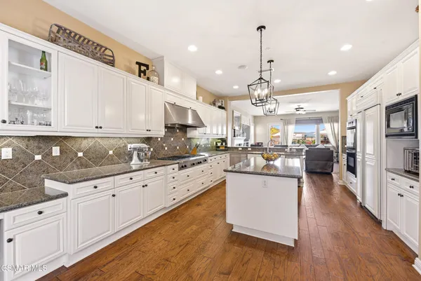 a view of city from a balcony with outdoor seating