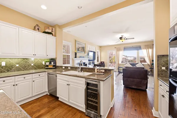 a spacious bathroom with a granite countertop sink a mirror a bathtub and shower