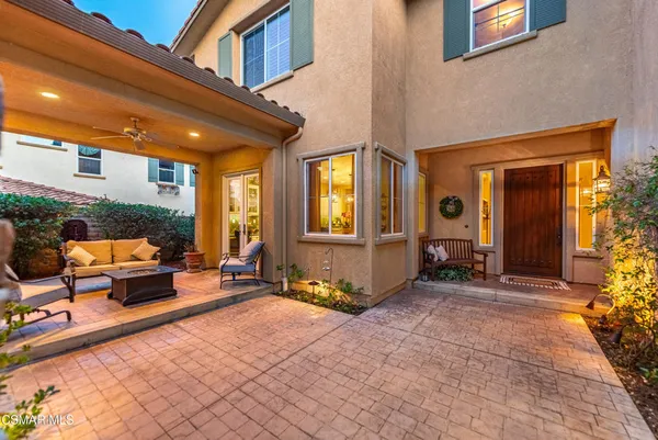 a view of a swimming pool with lawn chairs under an umbrella