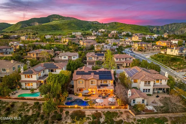 a view of a living room filled with furniture hardwood floor and a table