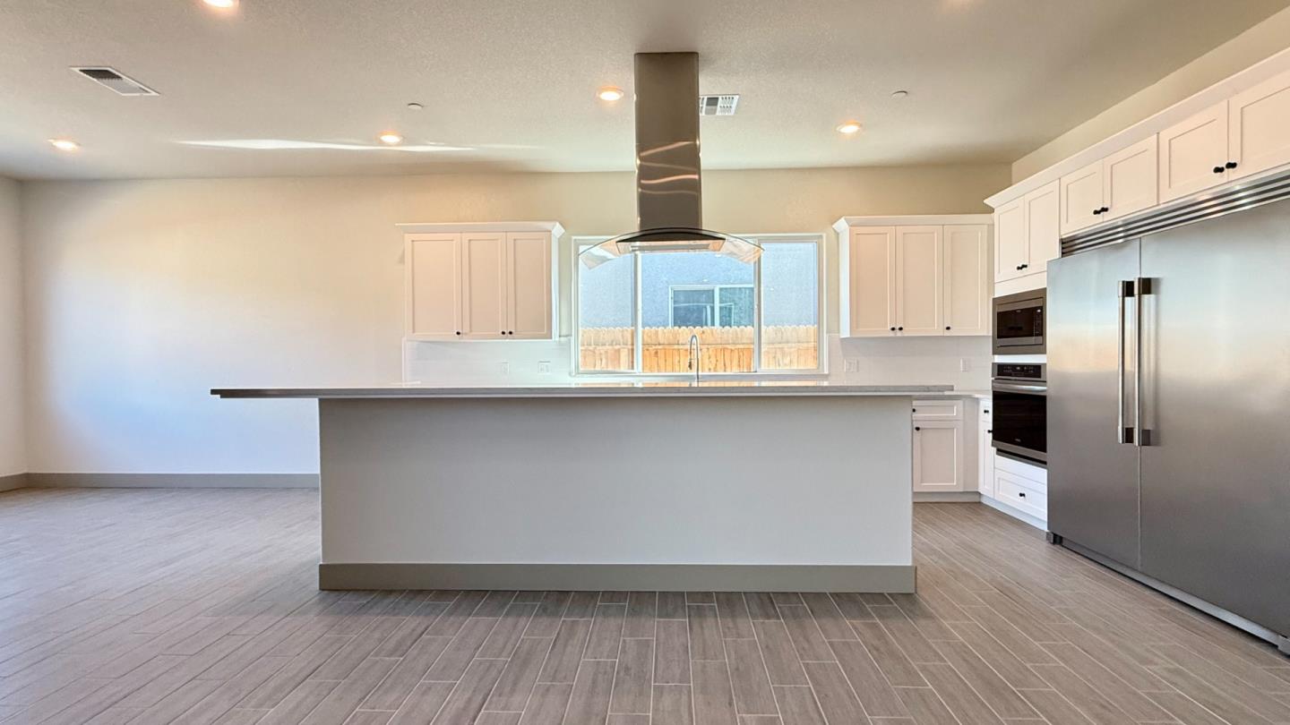 2475 Bastidas Drive Merced, CA 95340 - Photo 18 of 59 a kitchen with stainless steel appliances a refrigerator and a stove top oven