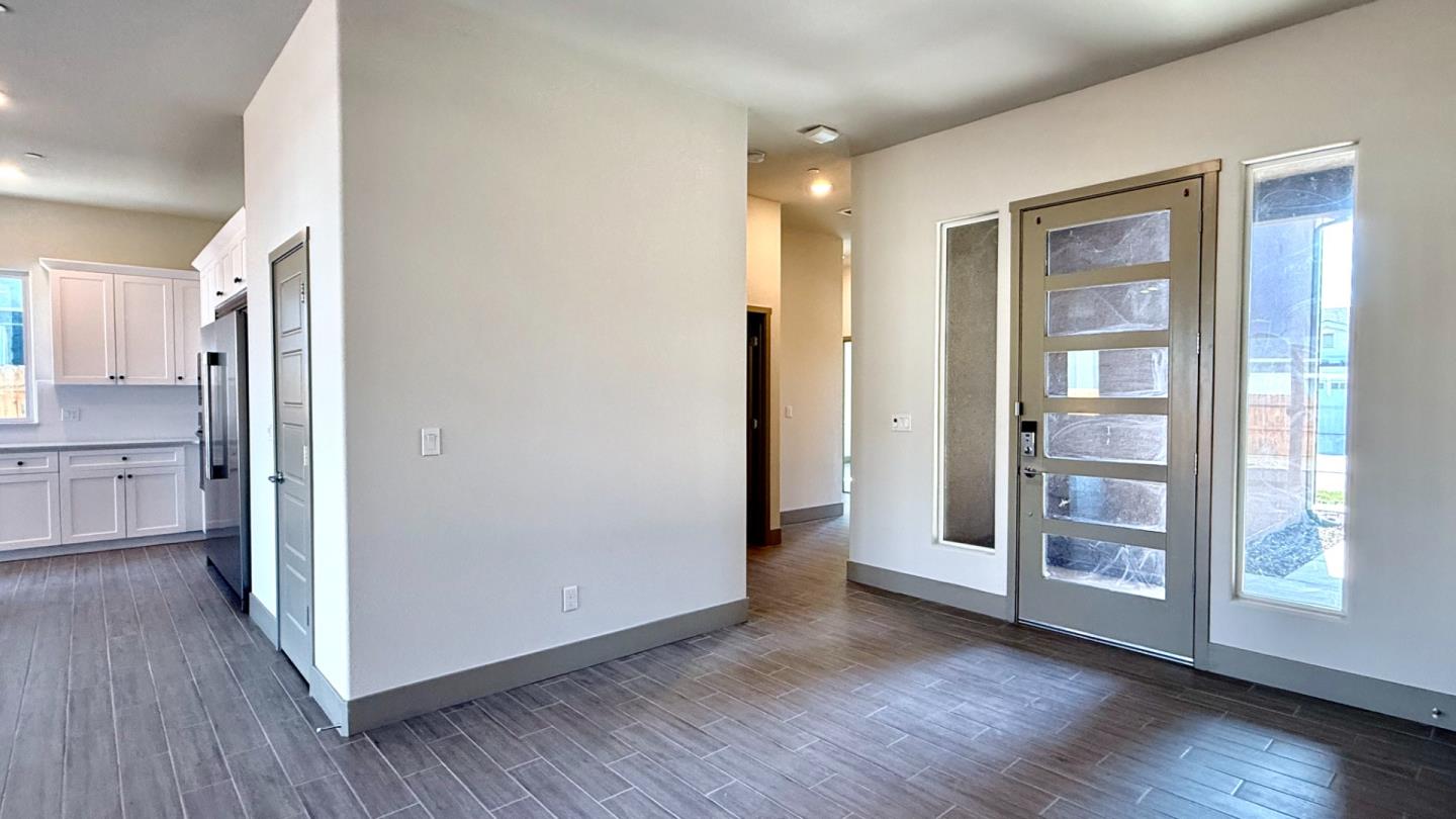 2475 Bastidas Drive Merced, CA 95340 - Photo 6 of 59 a view of a kitchen with wooden floor and a refrigerator