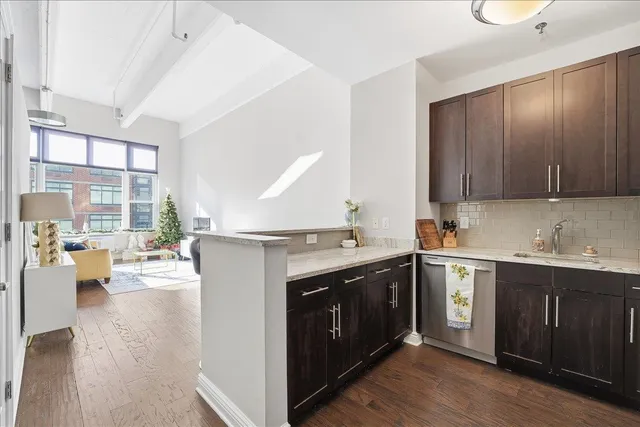 a kitchen with a sink stove and wooden cabinets