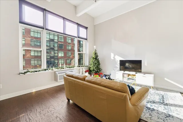 a living room with furniture window and a flat screen tv