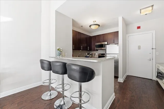 a kitchen with stainless steel appliances granite countertop a sink and cabinets
