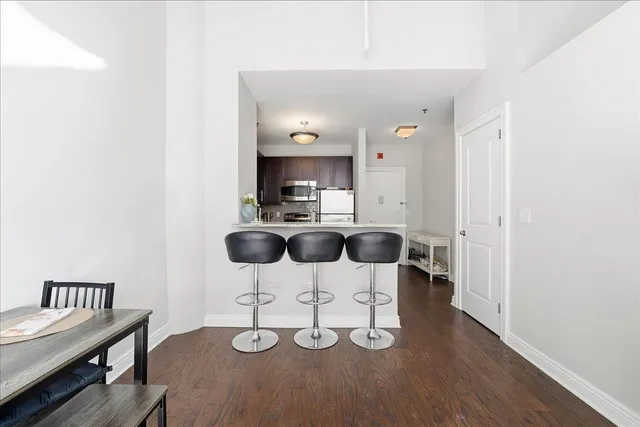 a kitchen with dining table and chairs