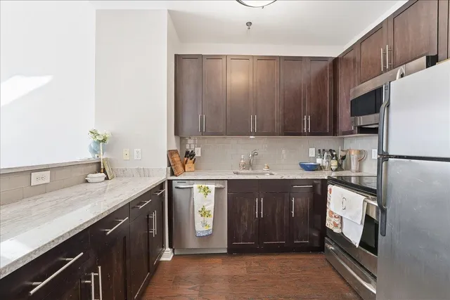 a kitchen with a sink a stove and cabinets