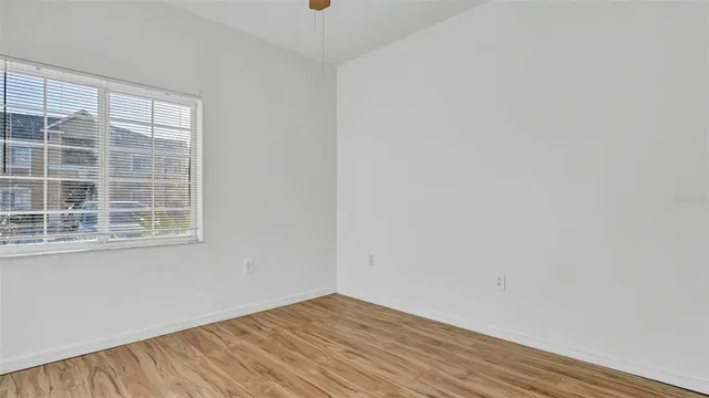 a bathroom with a granite countertop toilet sink and mirror