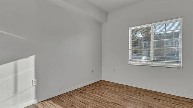 wooden floor in an empty room with a window