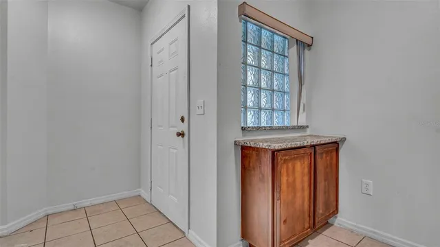 a view of kitchen with stainless steel appliances granite countertop cabinets and a refrigerator