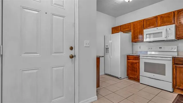 a kitchen with stainless steel appliances white cabinets and a stove top oven