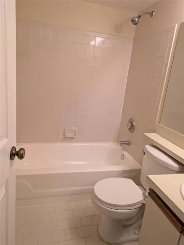 a bathroom with a bathtub a toilet and a shower