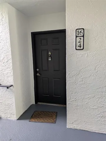 a view of a park with a bench plants and trees