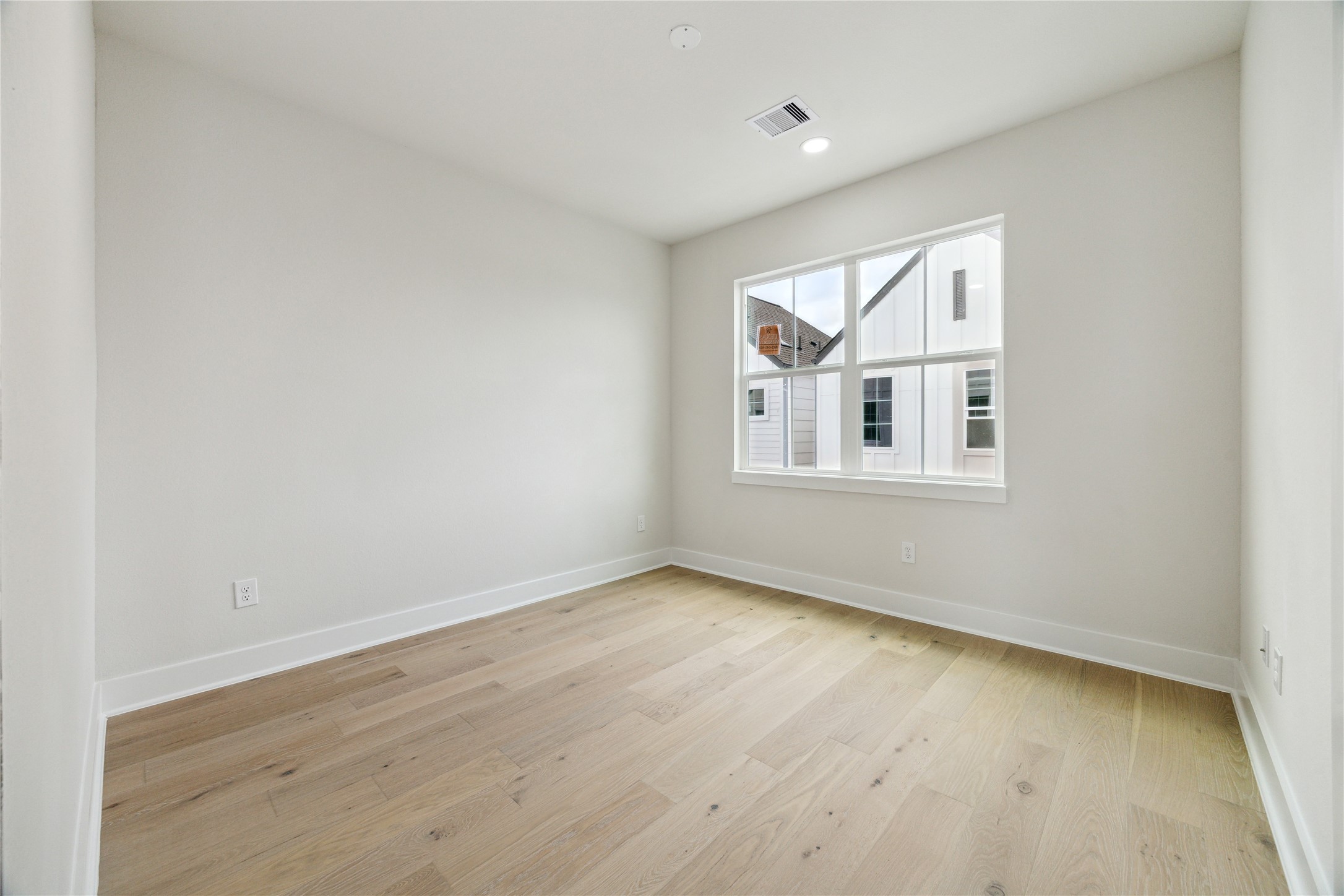 3911 Tulane Street, Unit B Houston, TX 77018 - Photo 25 of 37 Bright and airy third-floor bedroom with a large window, offering a serene retreat.
