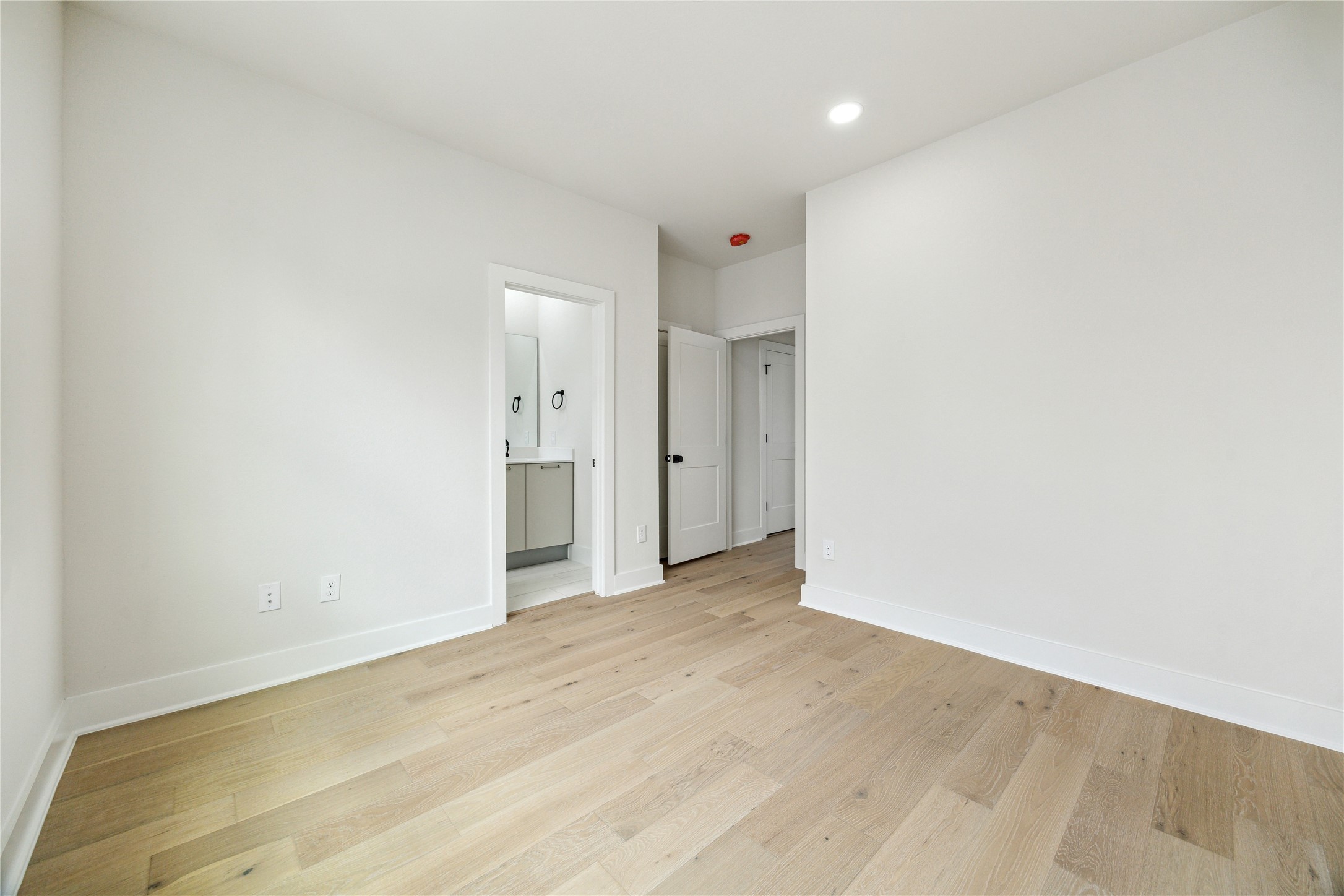 3911 Tulane Street, Unit B Houston, TX 77018 - Photo 26 of 37 Spacious third-floor bedroom with elegant hardwood floors and an ensuite bathroom.