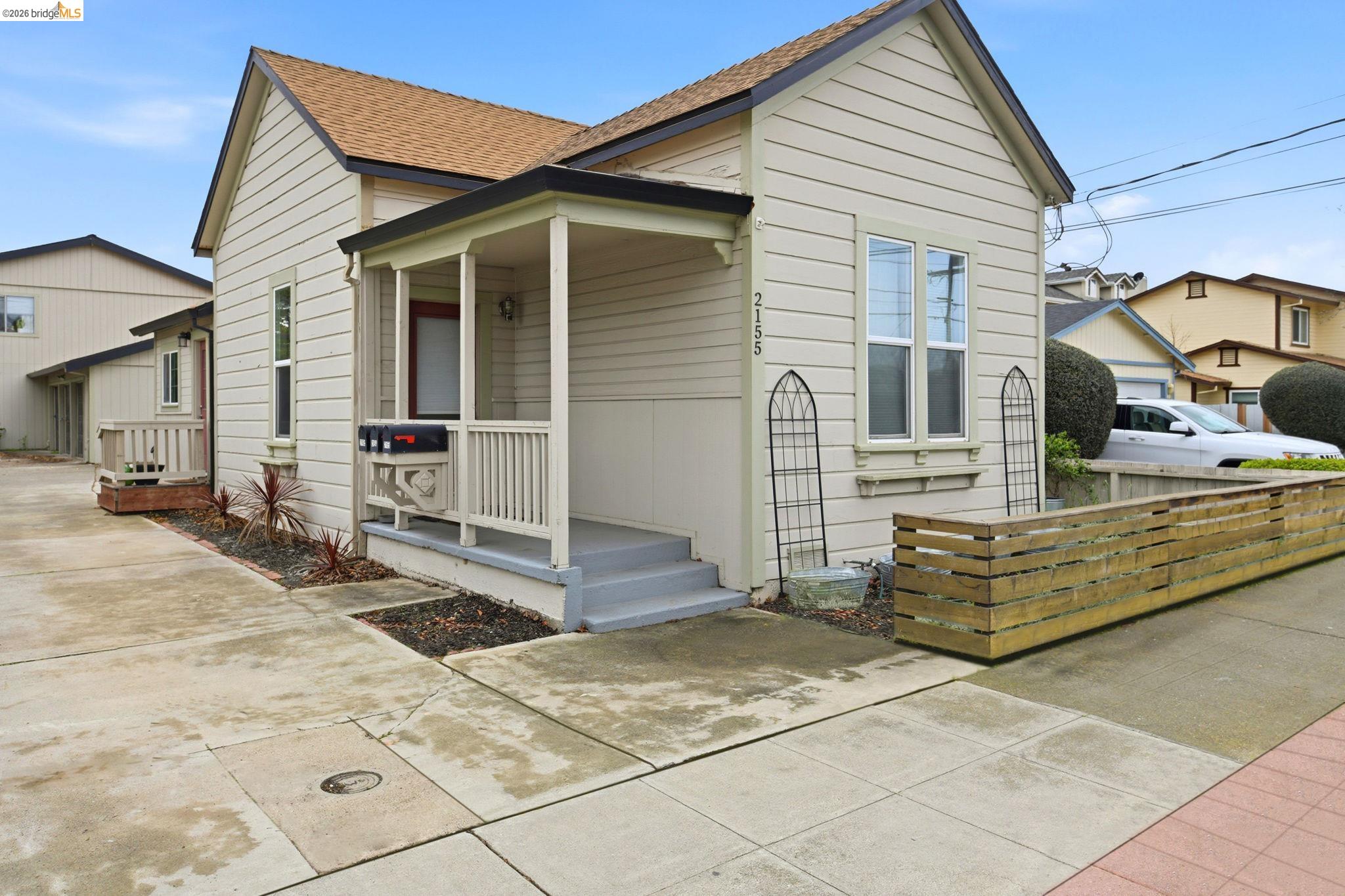 View of front of house featuring roof with shingles and a porch