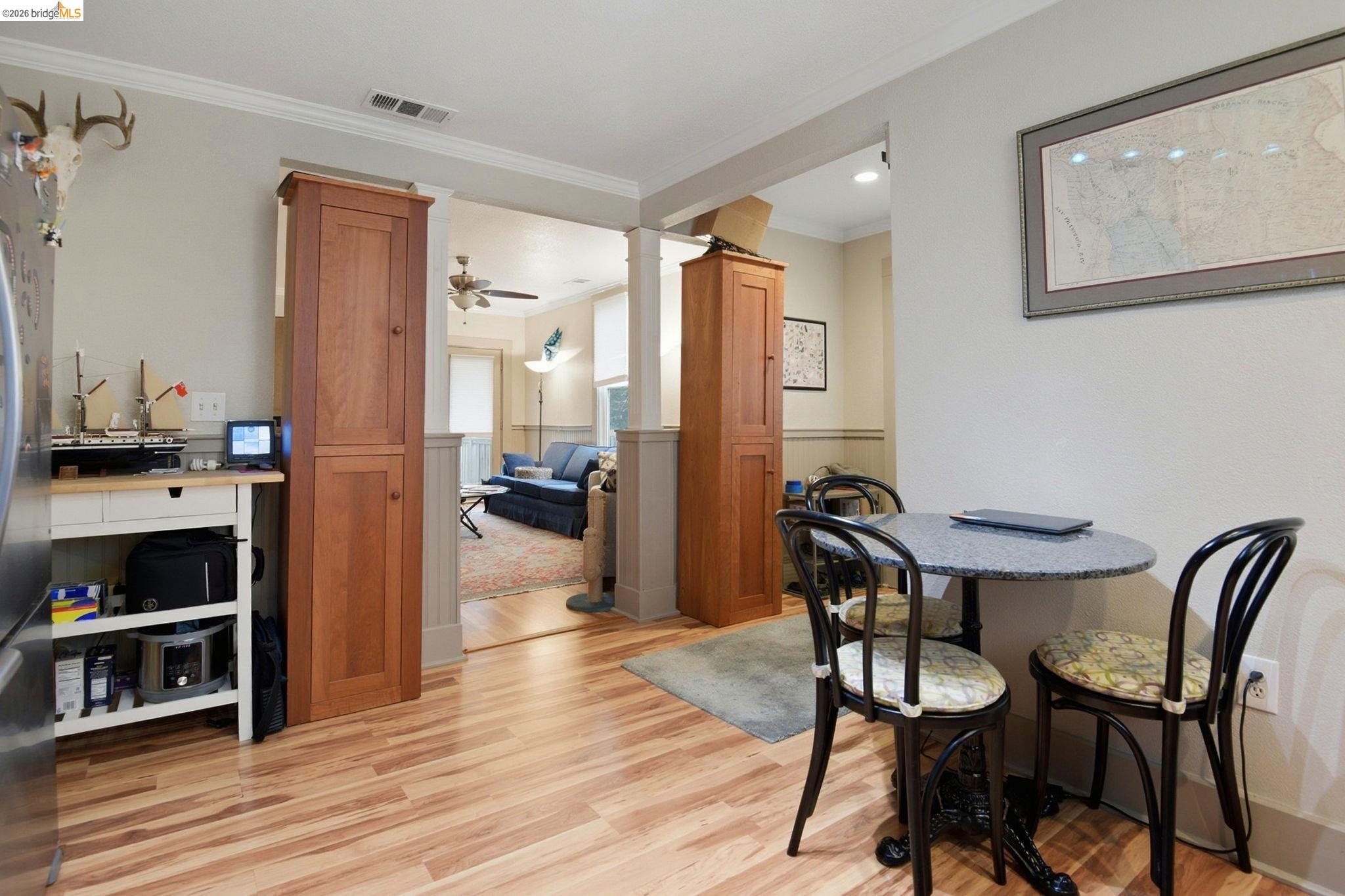 2155 Chestnut Street Livermore, CA 94551 - Photo 11 of 44 Dining room featuring ornamental molding, light wood finished floors, ornate columns, and ceiling fan
