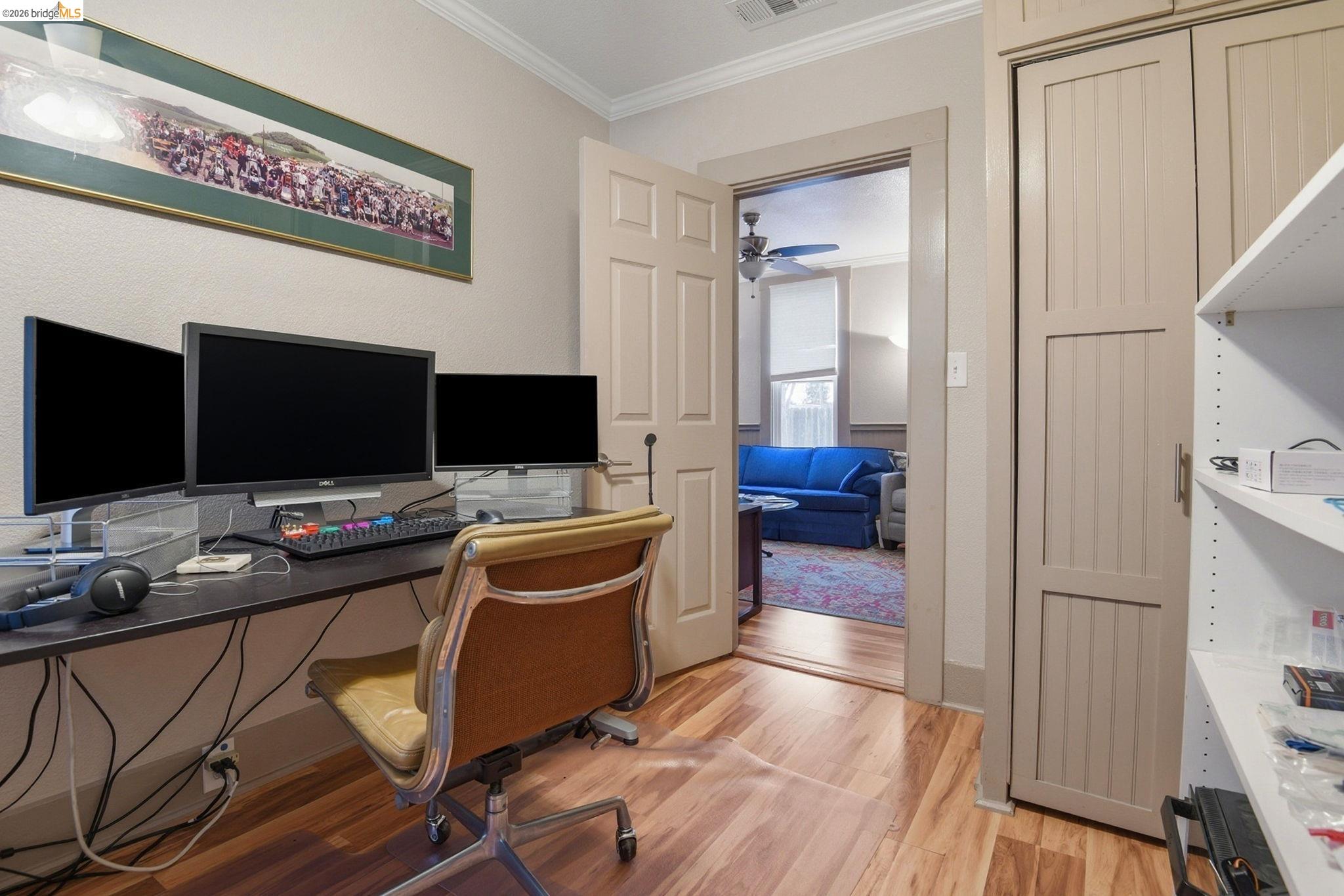 2155 Chestnut Street Livermore, CA 94551 - Photo 15 of 44 Home office with light wood-style flooring, crown molding, and a ceiling fan