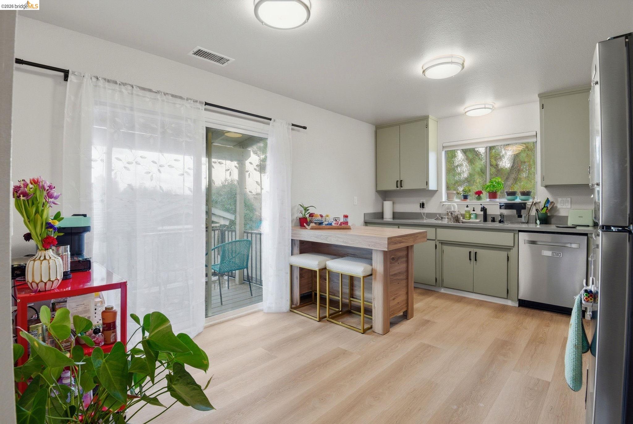 2155 Chestnut Street Livermore, CA 94551 - Photo 34 of 44 Kitchen featuring a breakfast bar area, a peninsula, light countertops, light wood-style flooring, and stainless steel appliances