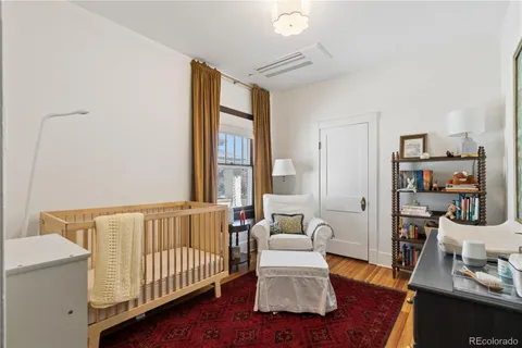 a living room with furniture and a book shelf