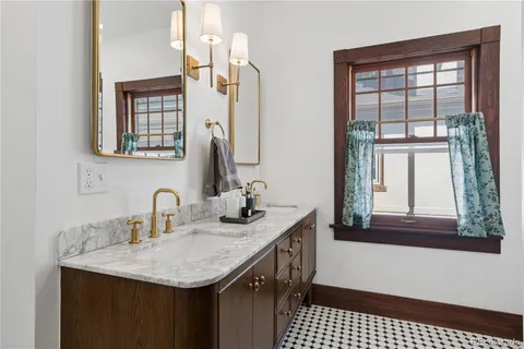 a bathroom with a sink vanity and a mirror