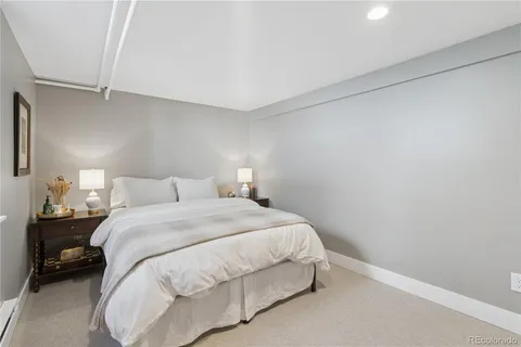 a bedroom with a bed and a night stand