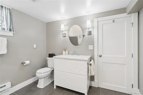 a bathroom with a toilet a sink and a mirror