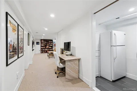 a view of a workspace with furniture and a window