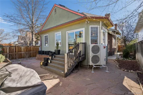 a view of a house with backyard and furniture