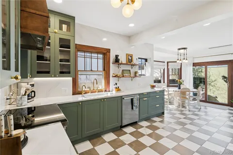 a kitchen with a sink and chairs