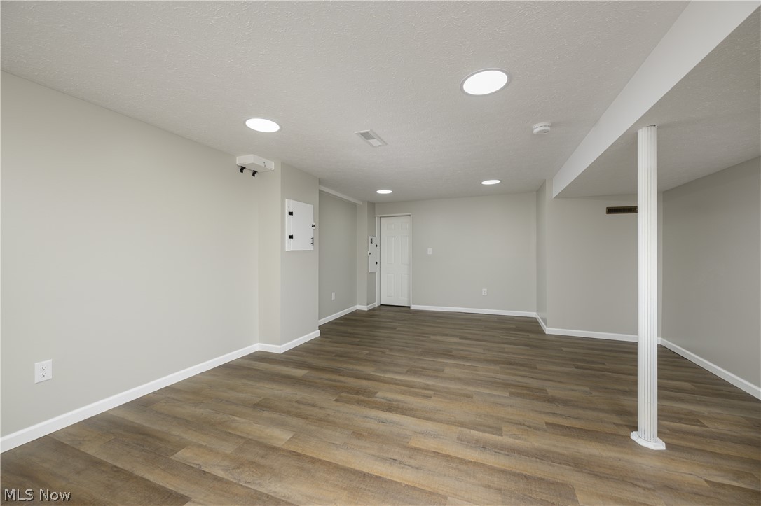 4855 4th Street Northwest Canton, OH 44708 - Photo 17 of 25 Basement with a textured ceiling and dark hardwood / wood-style flooring