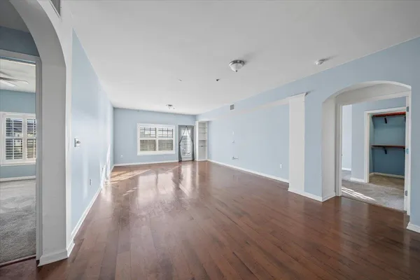 wooden floor in an empty room with a window