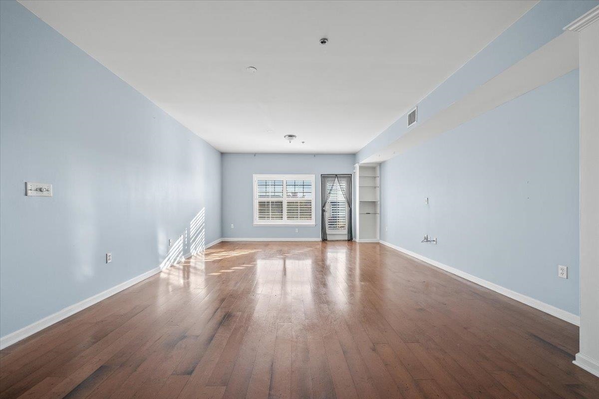 665 Tennessee Street, Unit 301 Memphis, TN 38103 - Photo 16 of 38 a view of empty room with wooden floor and fan