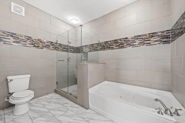 a bathroom with a toilet a sink and bathtub