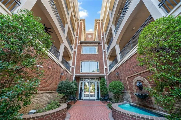 a front view of multi story residential apartment building with yard
