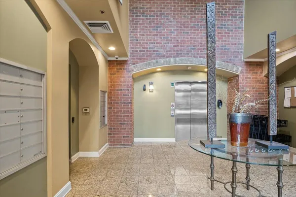 a bathroom with a glass shower door and mirror