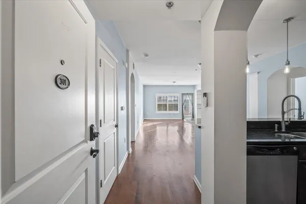 a view of a hallway with wooden floor and a fireplace