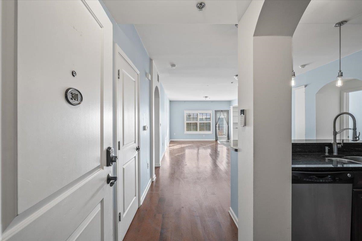 665 Tennessee Street, Unit 301 Memphis, TN 38103 - Photo 7 of 38 a view of a hallway with wooden floor and a fireplace