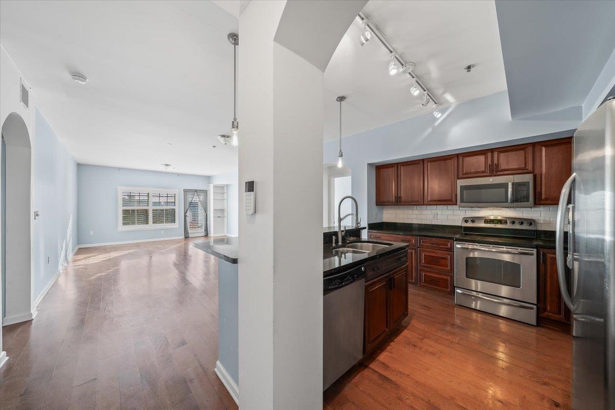 665 Tennessee Street, Unit 301 Memphis, TN 38103 - Photo 9 of 38 a kitchen with stainless steel appliances a stove top oven and a refrigerator