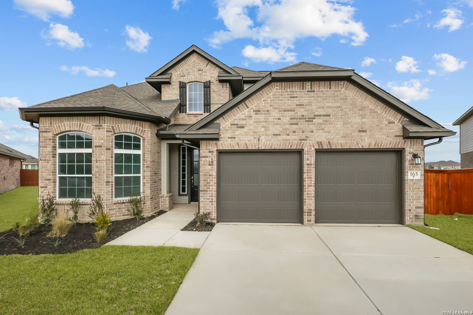 165 Mallorys Way Castroville, TX 78009 - Photo 1 of 34 a front view of a house with a yard