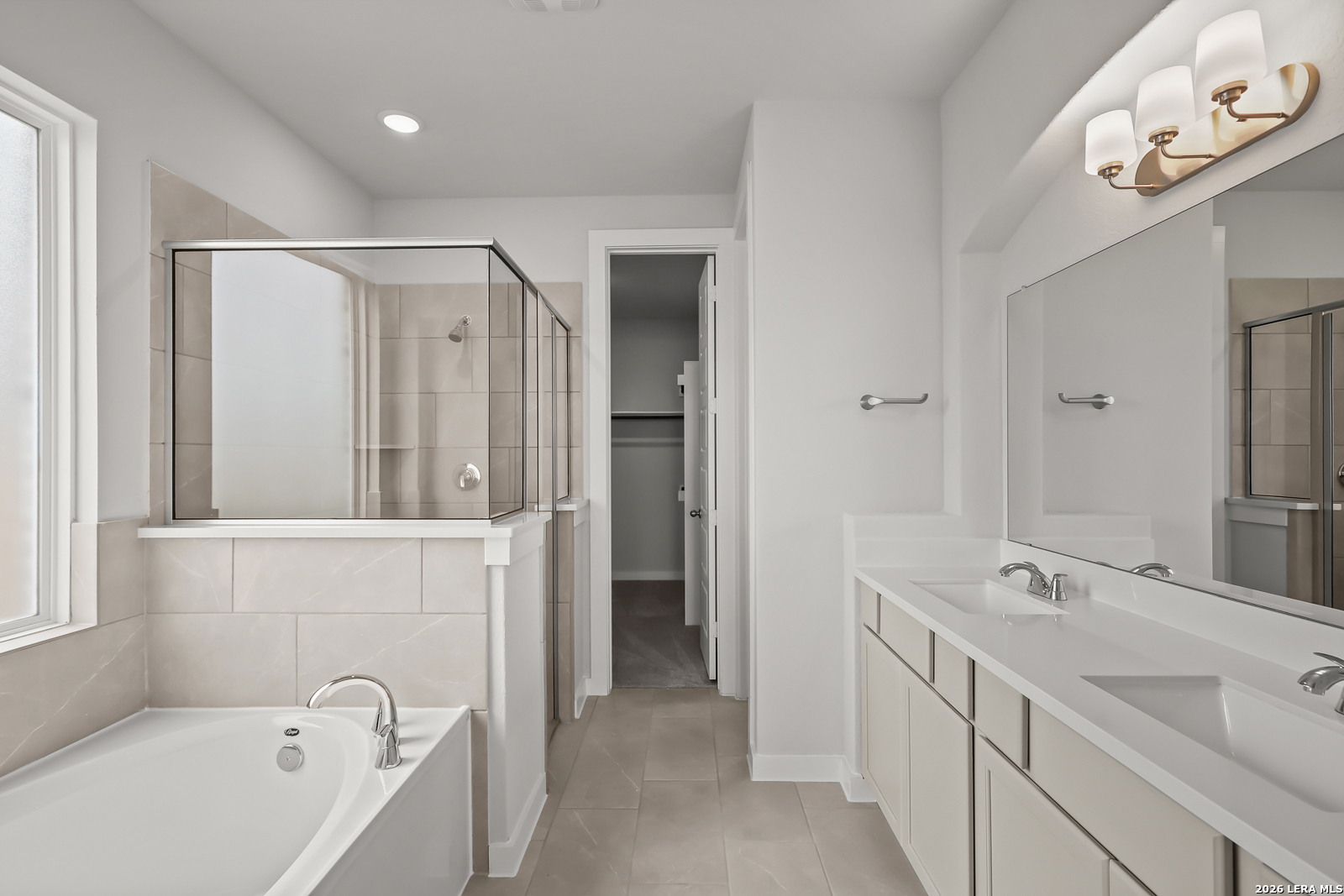165 Mallorys Way Castroville, TX 78009 - Photo 17 of 34 a bathroom with a tub sink and mirror