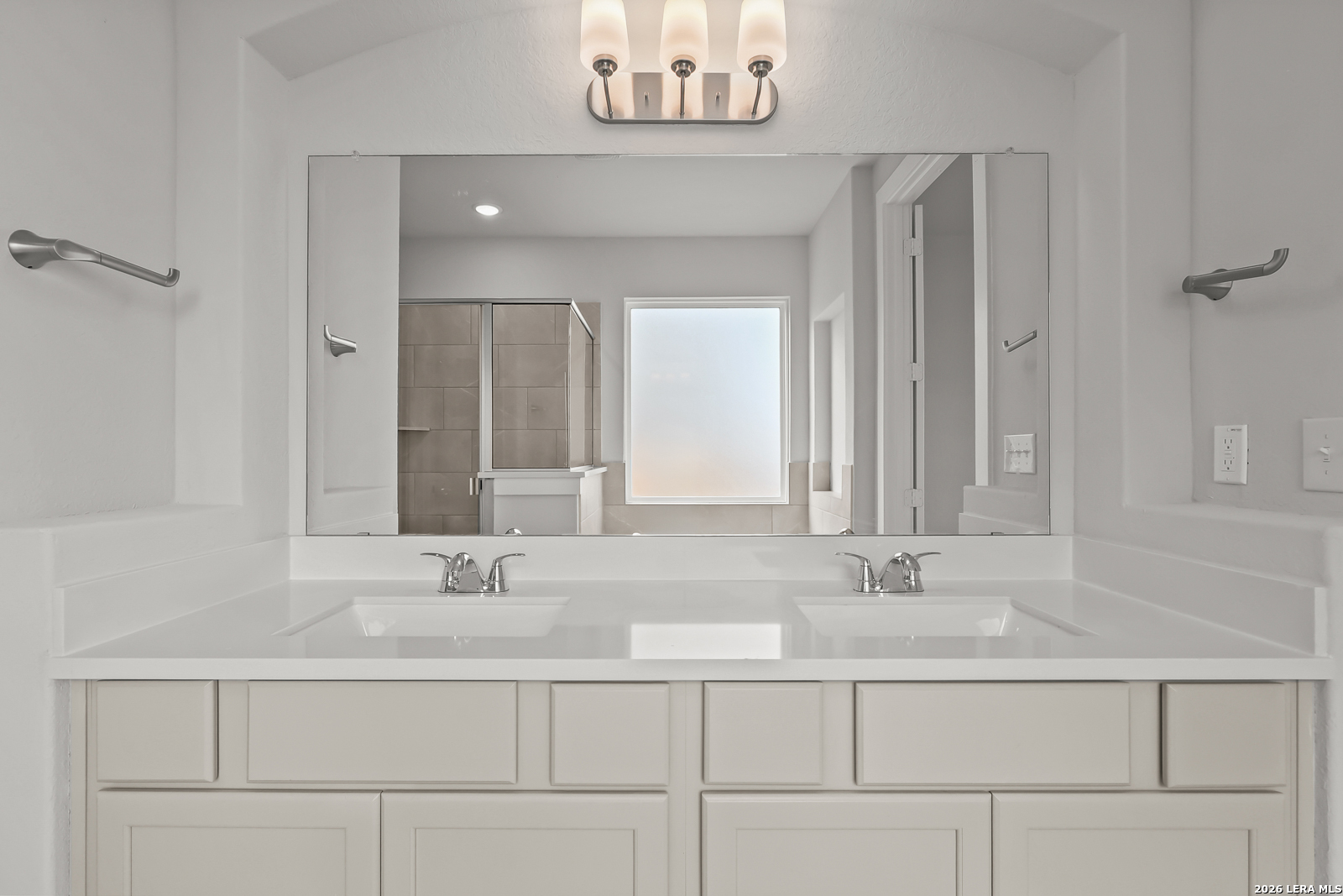 165 Mallorys Way Castroville, TX 78009 - Photo 19 of 34 a bathroom with a sink and a mirror