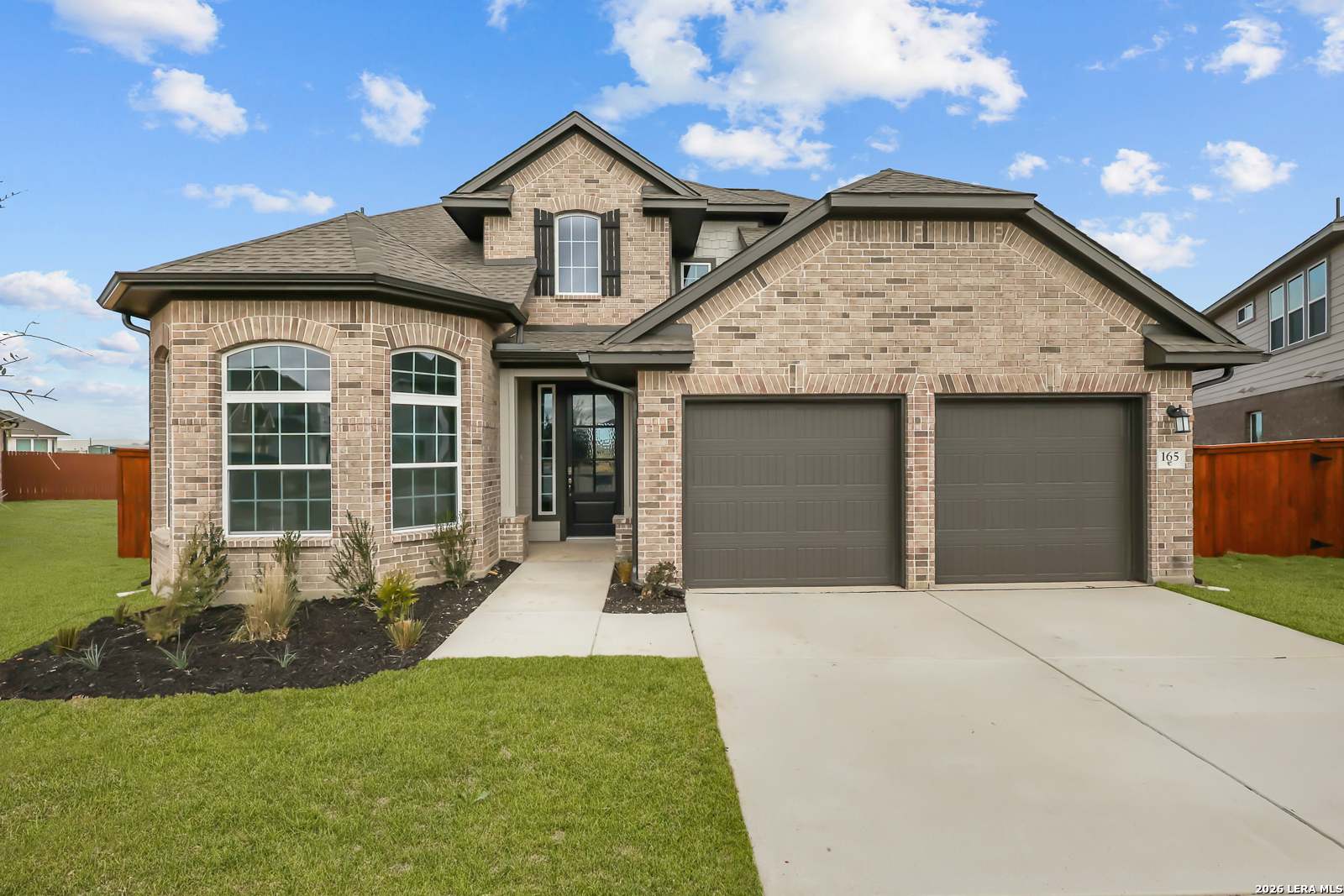 165 Mallorys Way Castroville, TX 78009 - Photo 2 of 34 a front view of a house with a yard