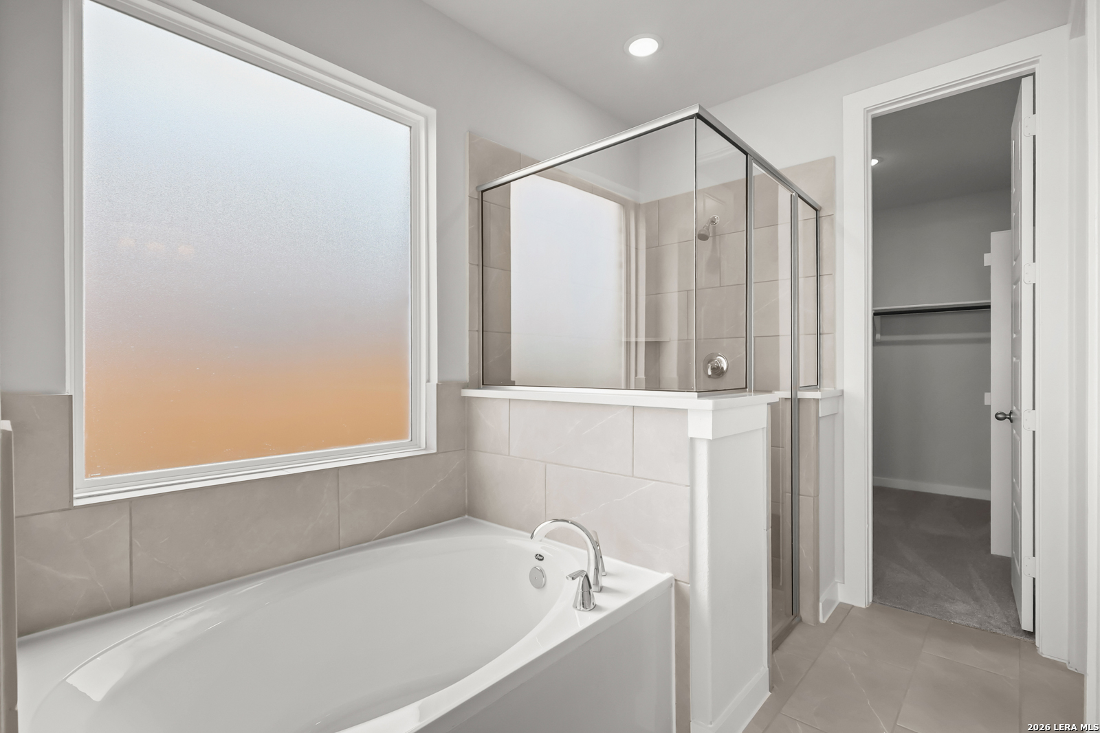 165 Mallorys Way Castroville, TX 78009 - Photo 22 of 34 a bathroom with a bathtub and a shower