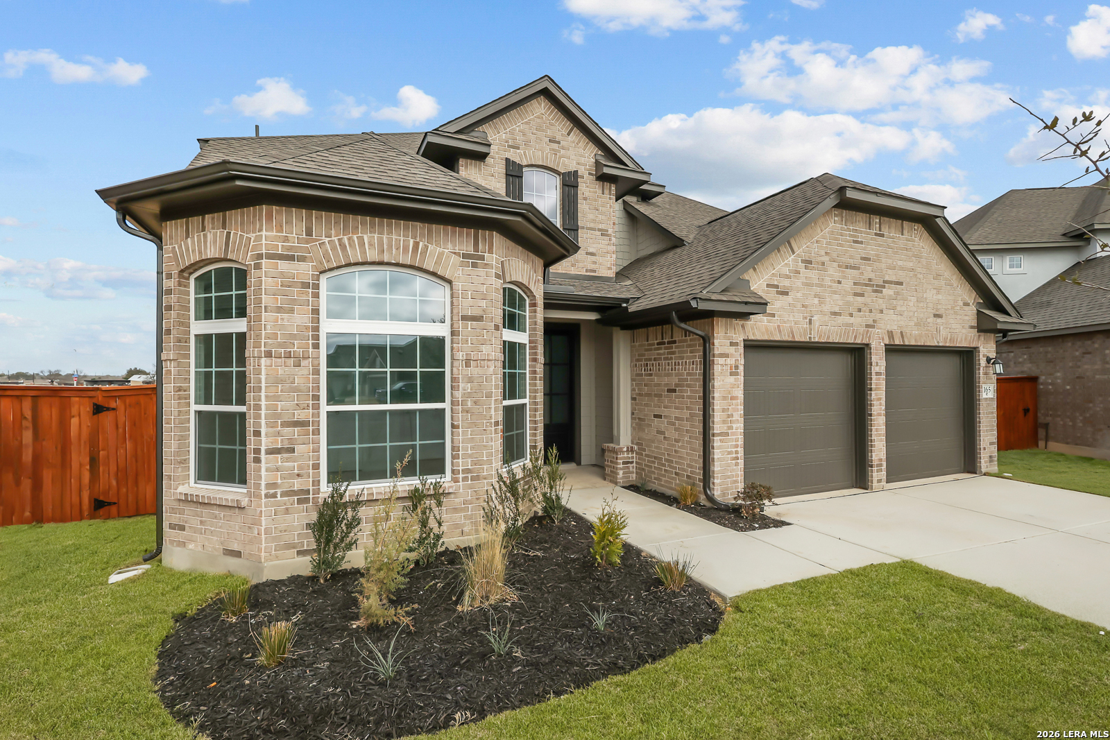 165 Mallorys Way Castroville, TX 78009 - Photo 3 of 34 a front view of a house with garden